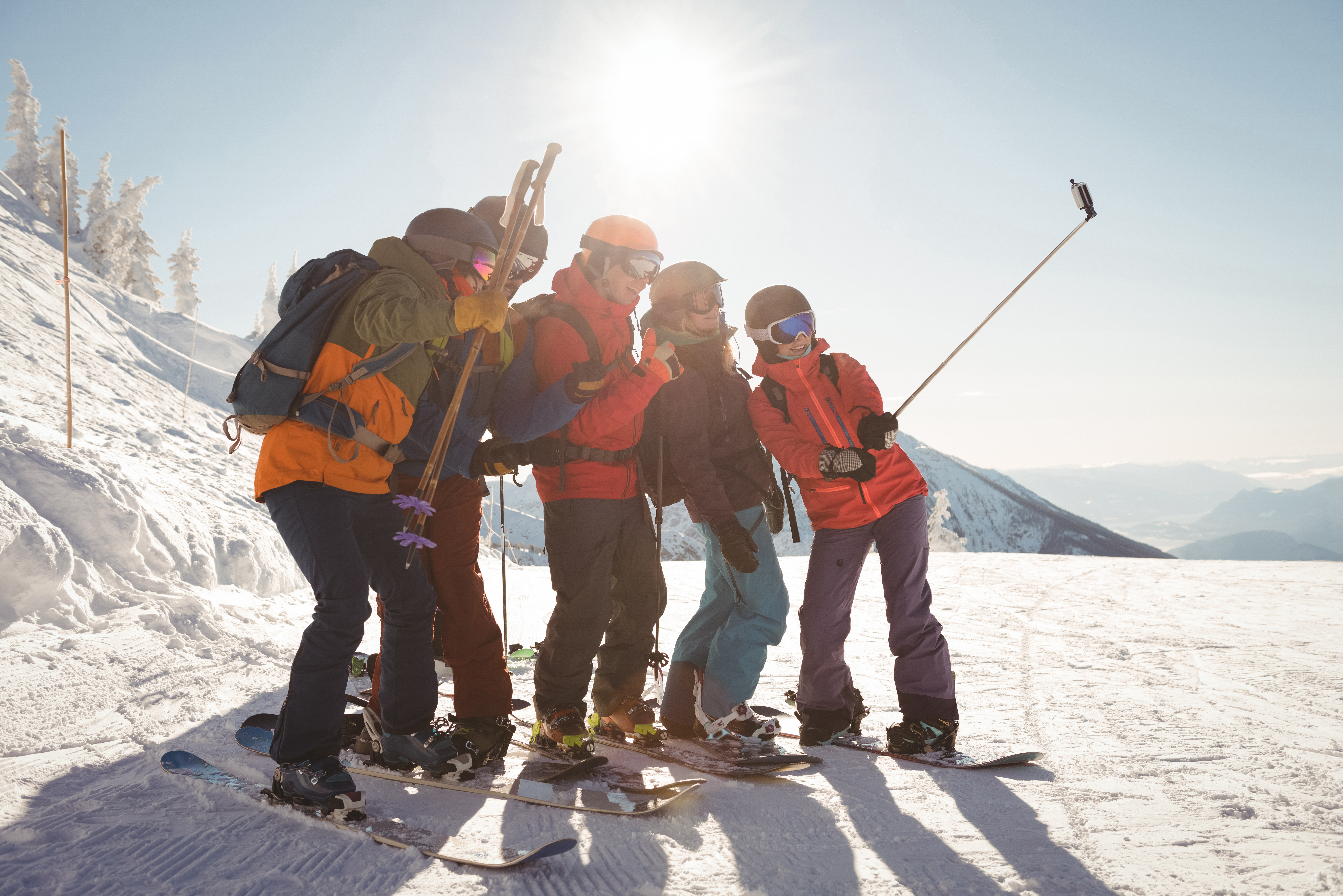 Group of skiers taking selfie on mobile phone during winter Group of skiers taking selfie on mobile phone during winter