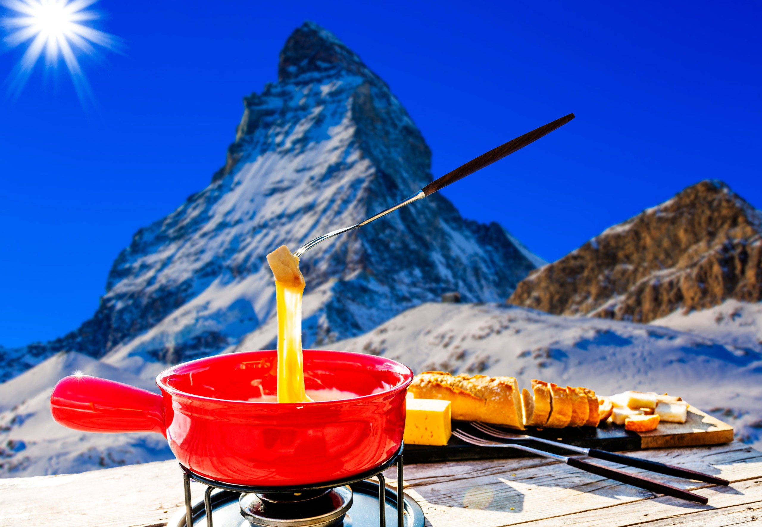 Fondue cheese, swiss winter ski holidays break for lunch, mountain view Matterhorn in Zermatt, Switzerland.