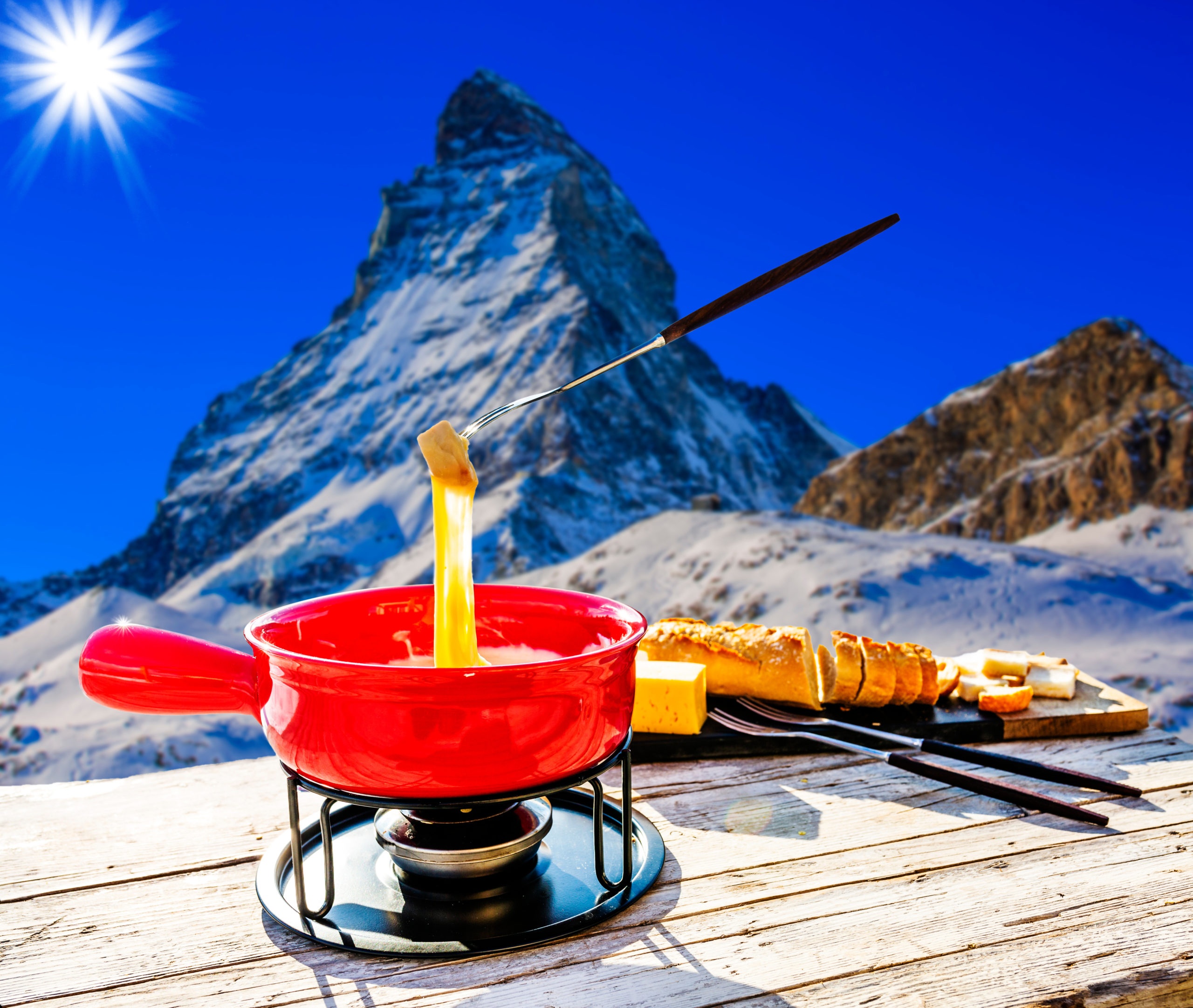 Fondue cheese, swiss winter ski holidays break for lunch, mountain view Matterhorn in Zermatt, Switzerland.